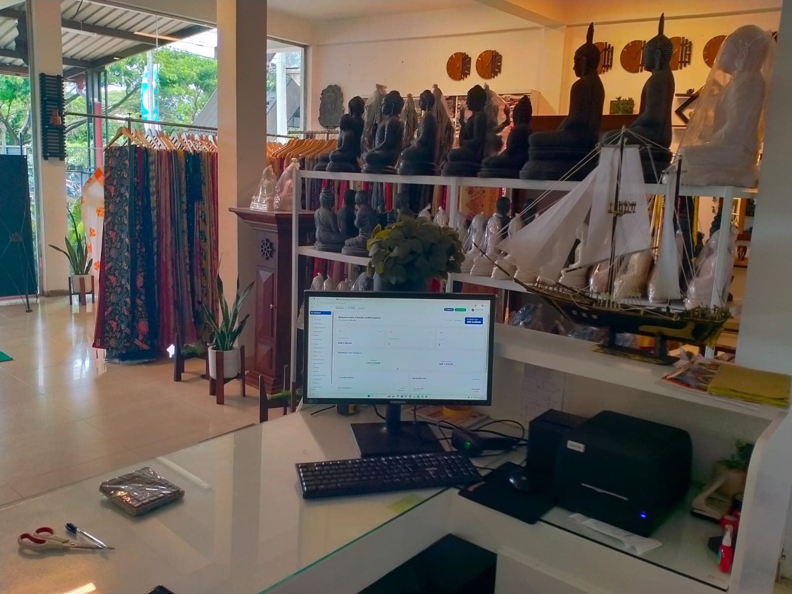 SellMate POS at the Sareeshop.lk saree showroom counter with receipt printer and barcode scanner