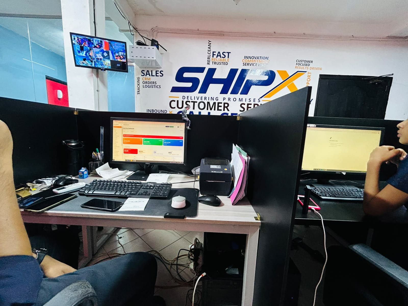 SellMate courier dashboard with a shipping label printer on a ShipX agent desk